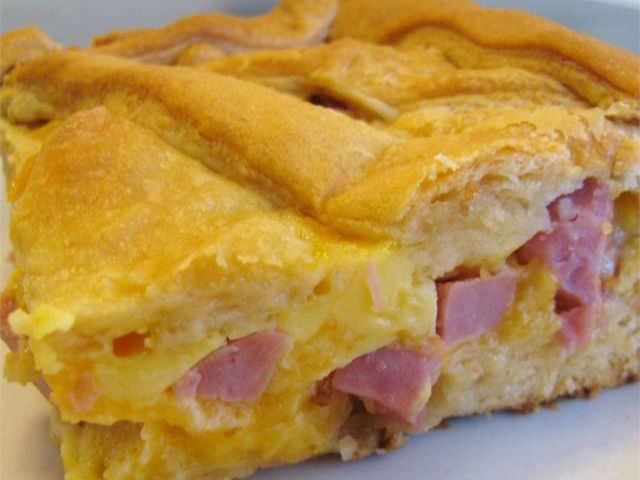 close up view of a slice of Ham and Cheese Pie on a plate
