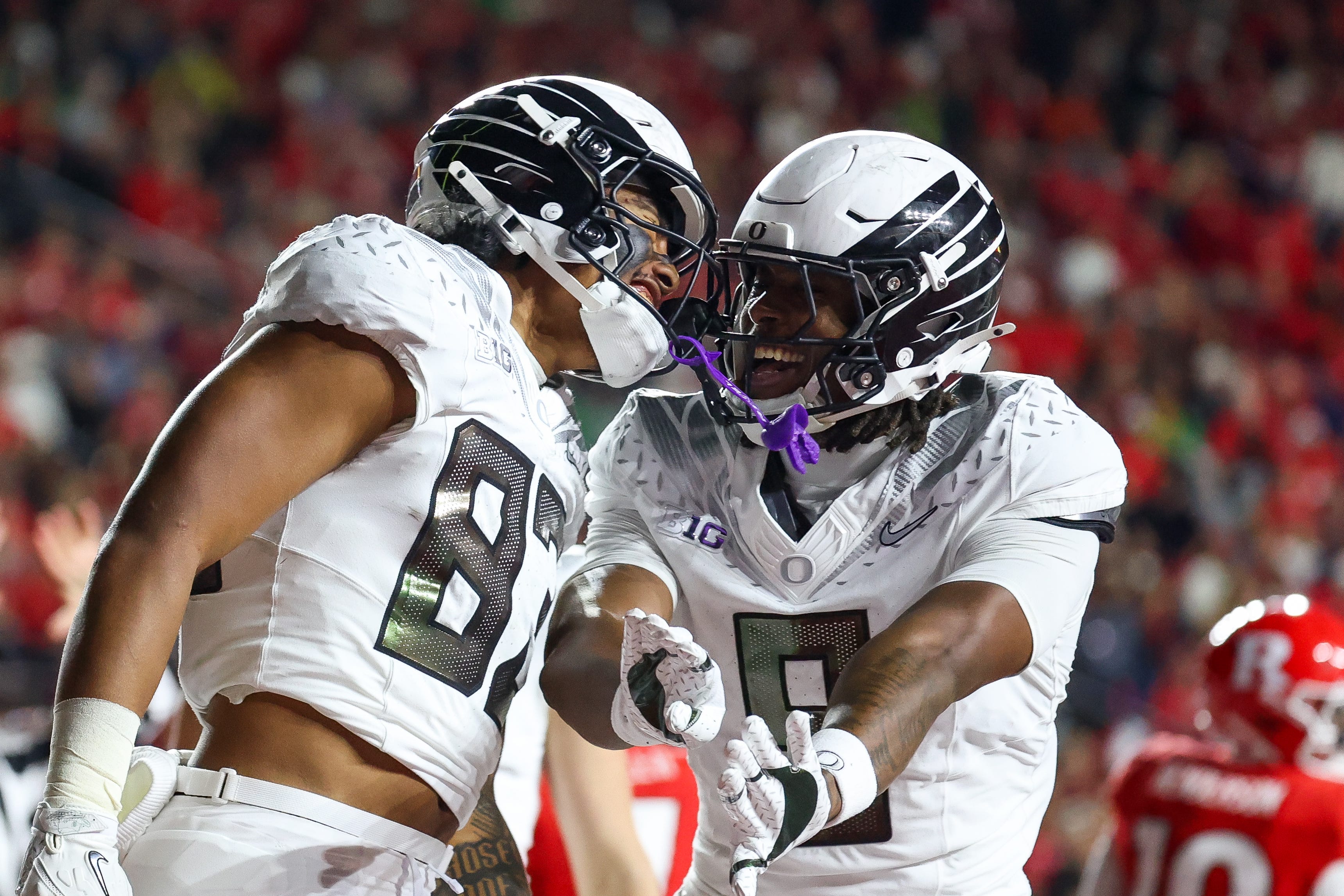 PISCATAWAY, NEW JERSEY - OCTOBER 18: Roger Saleapaga #83 of the Oregon Ducks celebrates with Jamari Johnson #9 of the Oregon Ducks after a play during the first quarter against the Rutgers Scarlet Knights at SHI Stadium on October 18, 2025 in Piscataway, New Jersey. (Photo by Isaiah Vazquez/Getty Images)