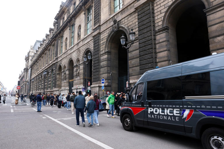 Police vehicle stands near the entrance to the Louvre museum (REUTERS)