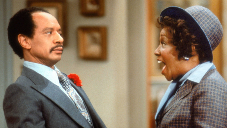 Louise Jefferson smiling excitedly at George in The Jeffersons