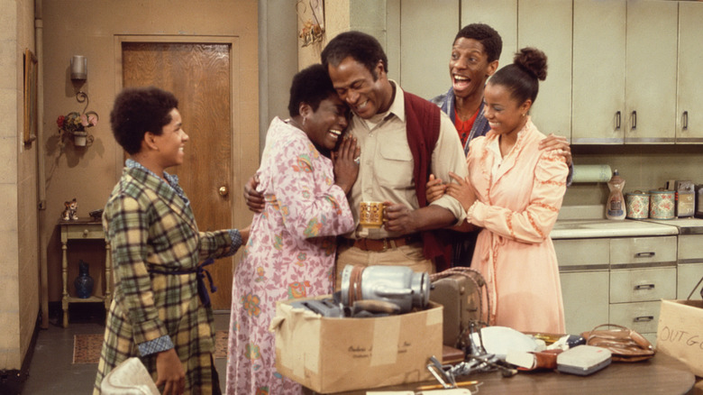 James and Florida Evans hugging while the kids smile around them in Good Times