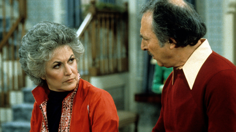 Maude Findlay looking at Walter Findlay with a frown in Maude