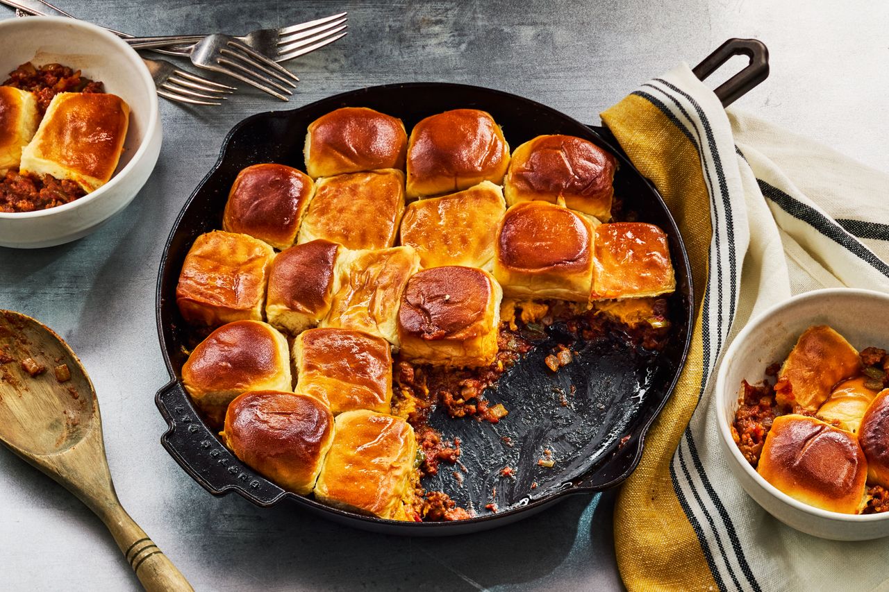 A pan of Sloppy Joe Casserole with a few scoops taken out and put in bowls