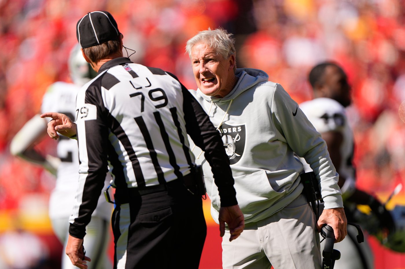 Las Vegas Raiders head coach Pete Carroll argues with line judge Kent Payne (79) during the second half of an NFL football game against the Kansas City Chiefs Sunday, Oct. 19, 2025, in Kansas City, Mo. (AP Photo/Charlie Riedel)