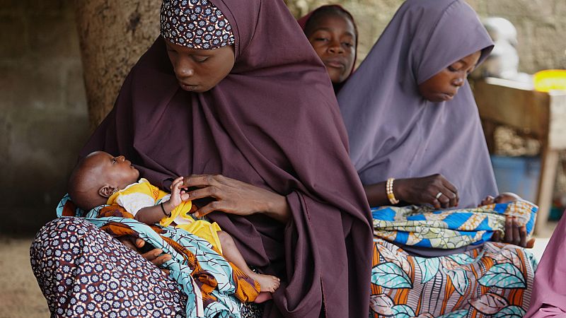 Aisha Muhammed, a 25-year-old woman, left, who had eclampsia, plays with one of her twins at her house in Konduga, in northeast Nigeria's Borno state, Wednesday, July 23, 2025