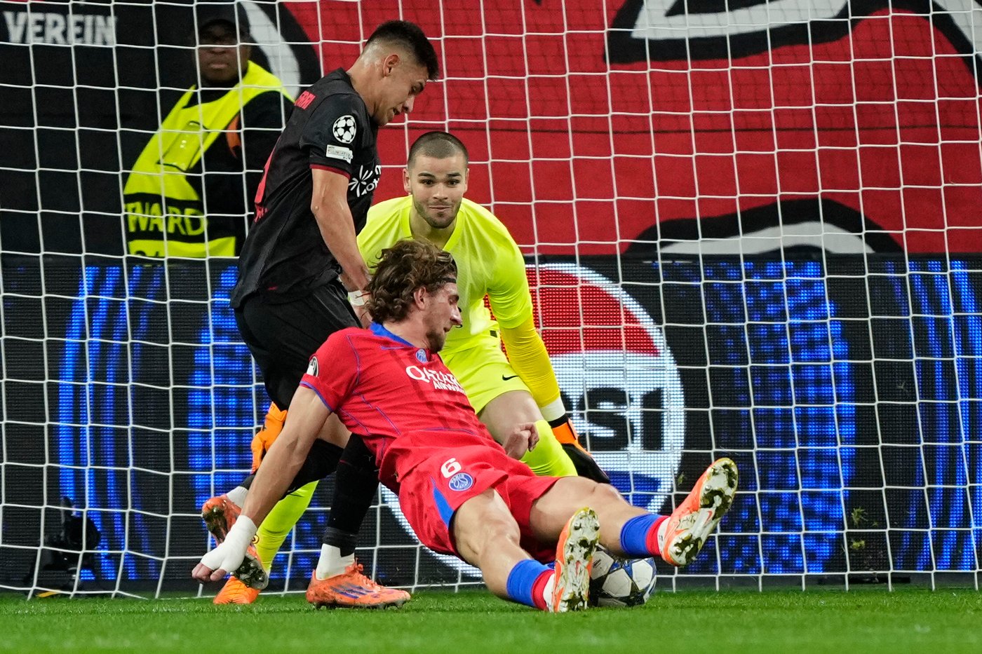 Leverkusen's Claudio Echeverri is fouled by PSG's Illya Zabarnyi during a Champions League opening phase soccer match between Bayer Leverkusen and Paris Saint-Germain in Leverkusen, Germany, Tuesday, Oct. 21, 2025. (AP Photo/Martin Meissner)