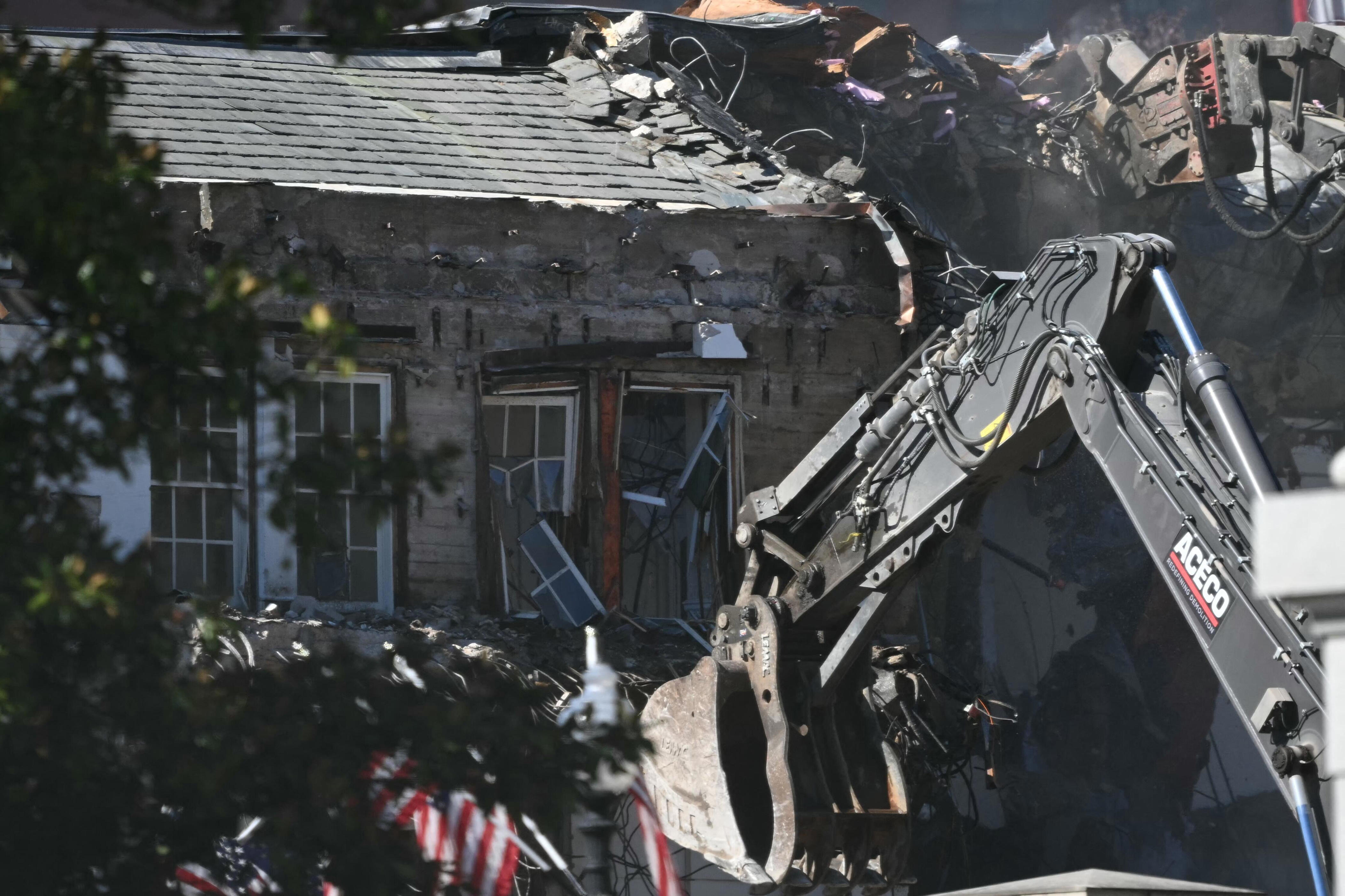 Heavy machinery tears down a section of the East Wing of the White House as construction begins on President Donald Trump's planned ballroom, in Washington, DC, on October 21, 2025. / Credit: DREW ANGERER/AFP via Getty Images