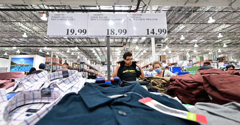 People shop for clothing at a Costco store in Monterey Park, California on November 22, 2022. 
