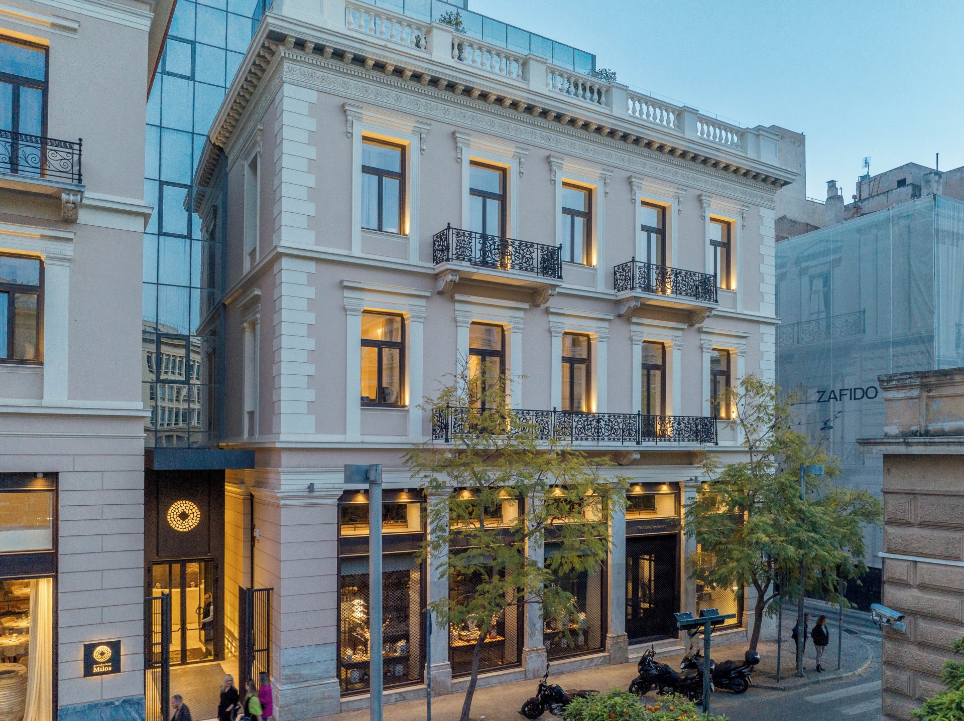 The facade of Xenodocheio Milos hotel in Athens, at night with underlights on
