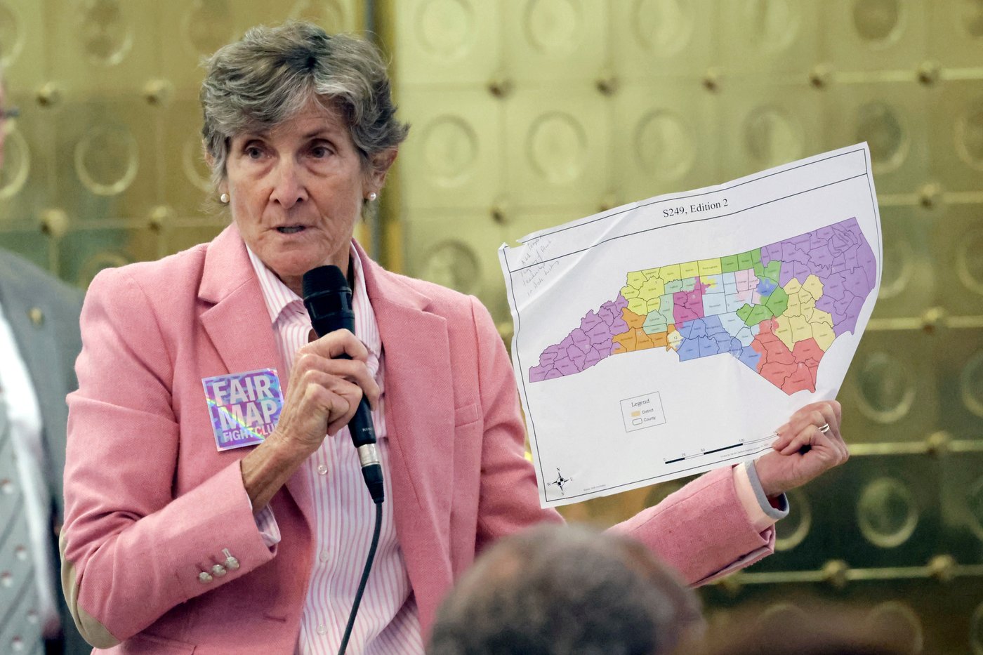 Rep. Pricey Harreison, D-Guilford, holds an alternative map as she speaks on a redistricting bill at the Legislative Building, Wednesday, Oct. 22, 2025, in Raleigh, N.C. (AP Photo/Chris Seward)