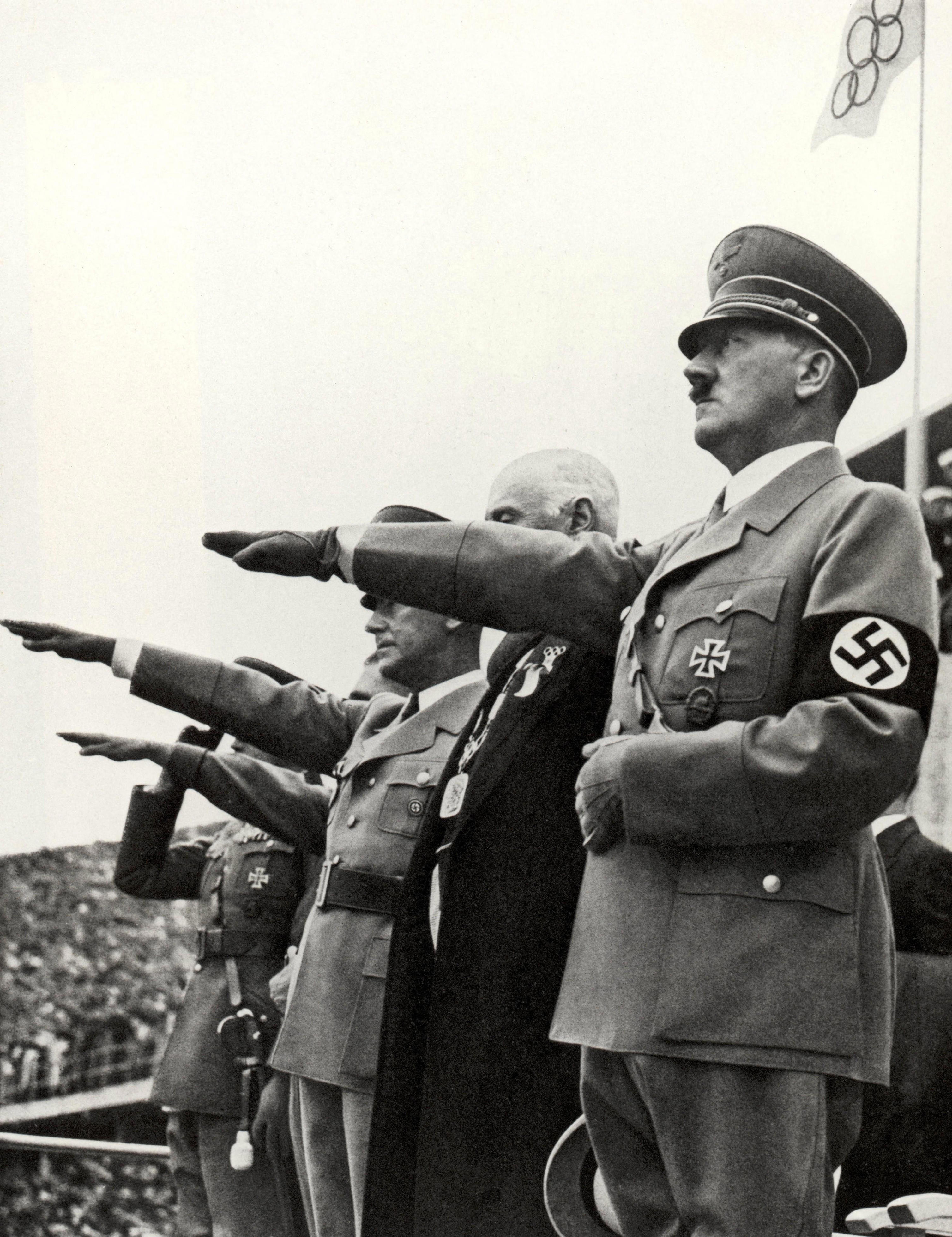 German Fuhrer Adolf Hitler takes the salute at the Berlin Olympic Games in 1936 World History Archive (Photo by Ann Ronan Picture Library / Photo12 via AFP)