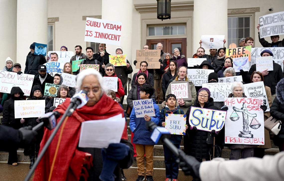 Supporters for Subramanyam ‘Subu' Vedam hold posters as Saraswathi Vedam talks about seeking justice for her brother before his Post-Conviction Relief Act hearing on Thursday, Feb. 6, 2025 at the Centre County Courthouse.