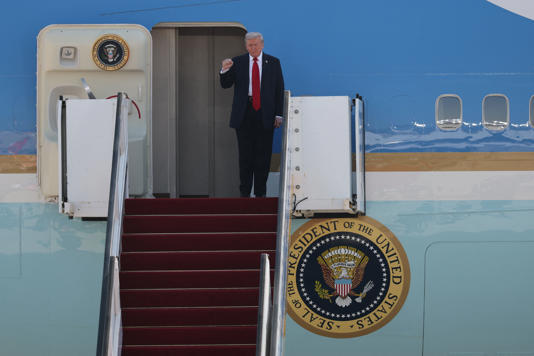 Donald Trump gestures after touching down at Ben Gurion airport on Monday (AFP via Getty Images)