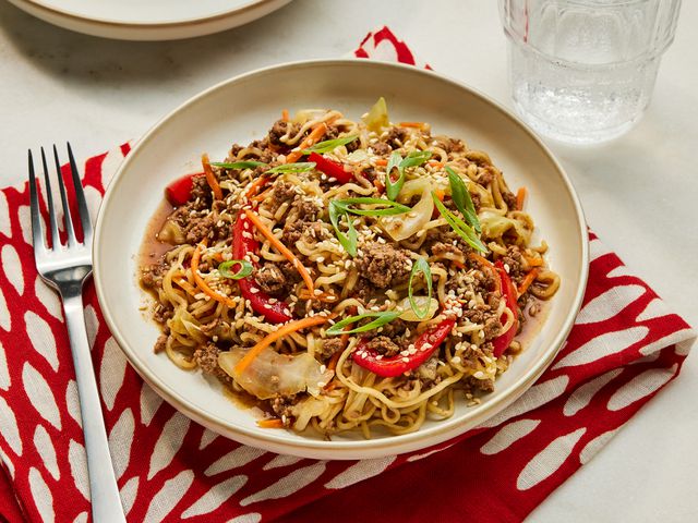 One-Pot Beef Ramen Noodles garnished with sesame seeds and green onions on a plate