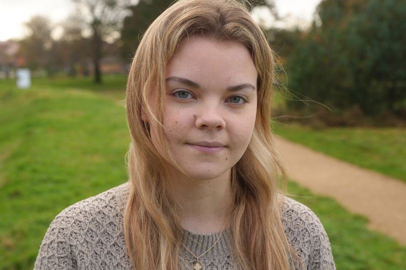 Eloise Cosser wears a beige jumper outdoors