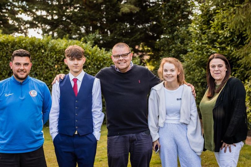Adam, Charlie, Martin, Tara and Eloise Cosser in a family photo outdoors