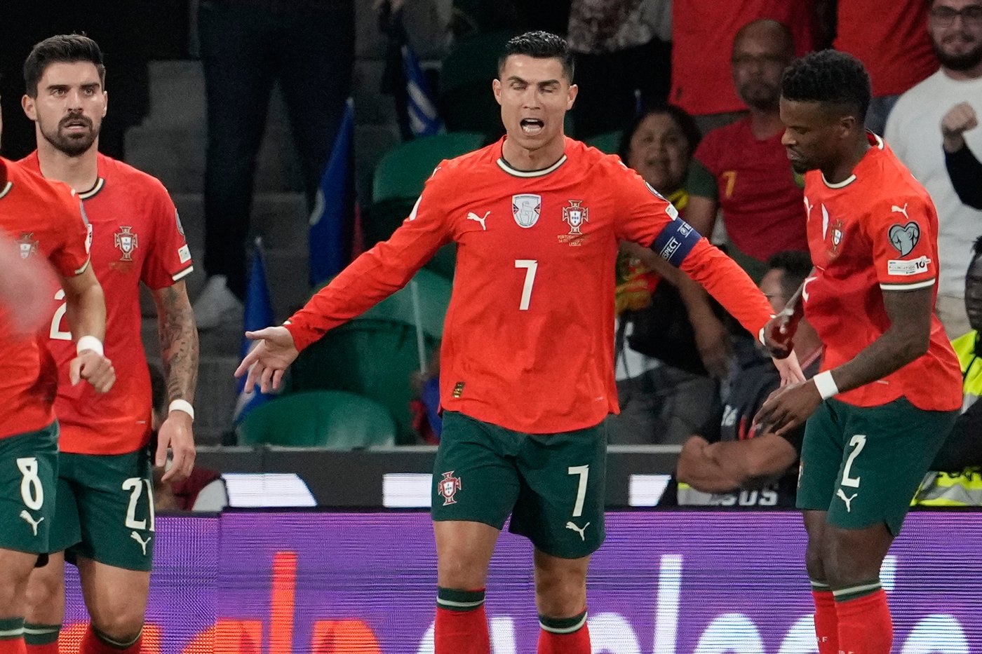 Portugal's Cristiano Ronaldo, center, celebrates after scoring during a World Cup 2026 group F qualifying soccer match between Portugal and Hungary in Lisbon, Tuesday, Oct. 14, 2025. (AP Photo/Armando Franca)