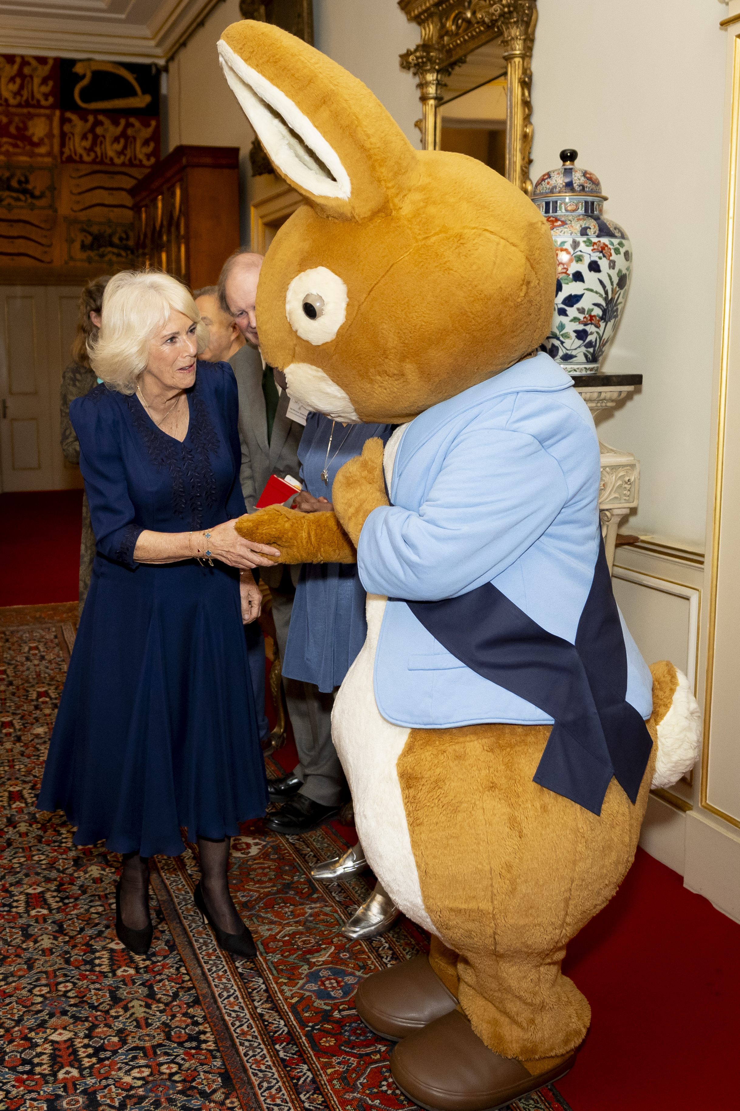 Queen meets Peter Rabbit as she wishes reading charity ‘happy 100th ...