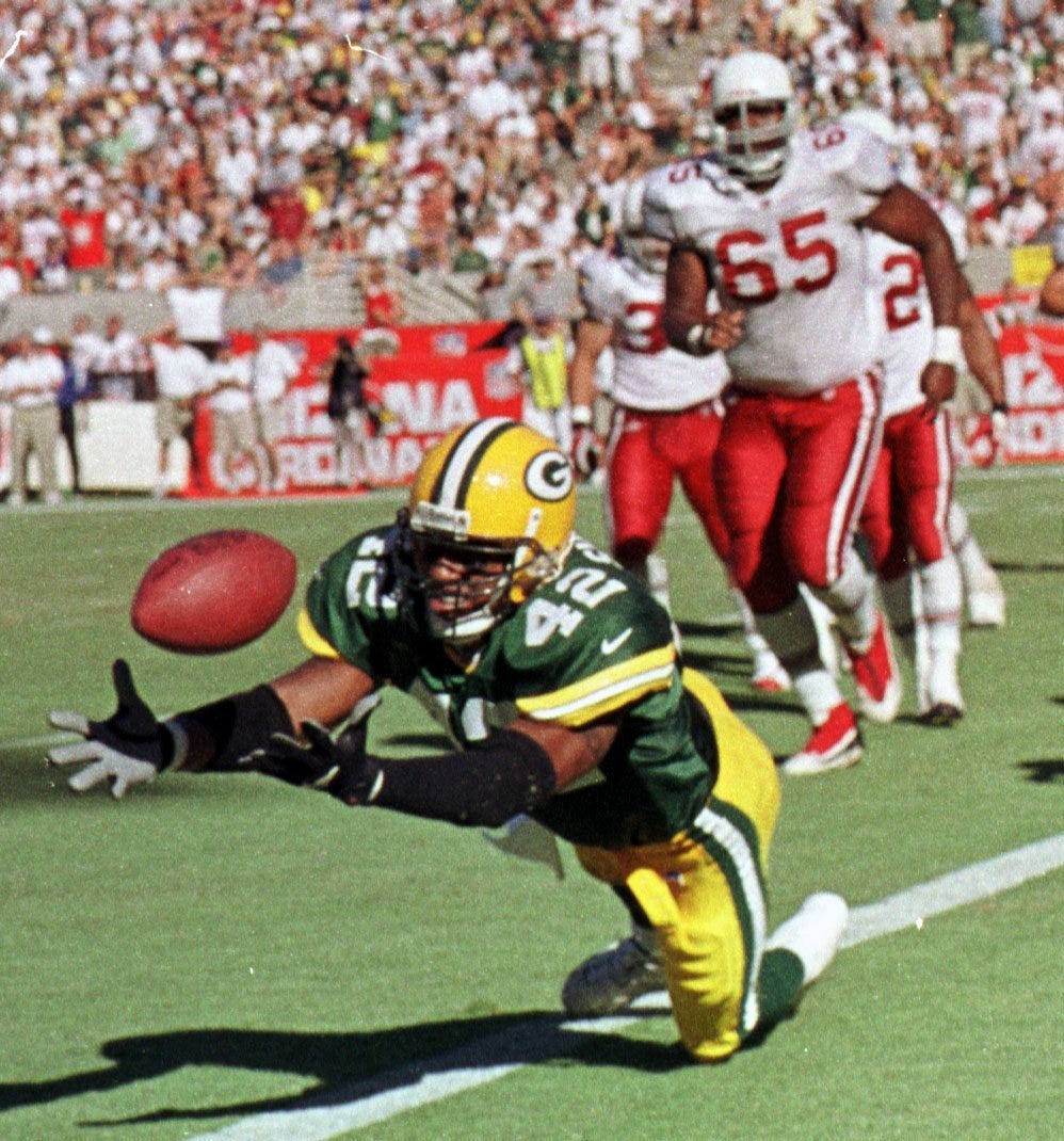 Green Bay Packers safety Darren Sharper makes a diving interception during the fourth quarter of their game against the Arizona Cardinals on September 24, 2000, at Sun Devil Stadium in Tempe, Ariz.