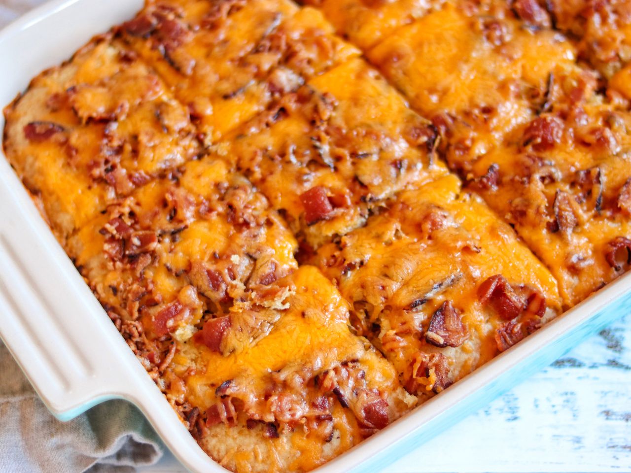 Pancake casserole topped with bacon and cheese