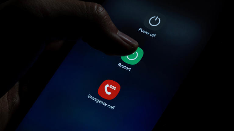Power menu of a Samsung Galaxy with someone pressing restart
