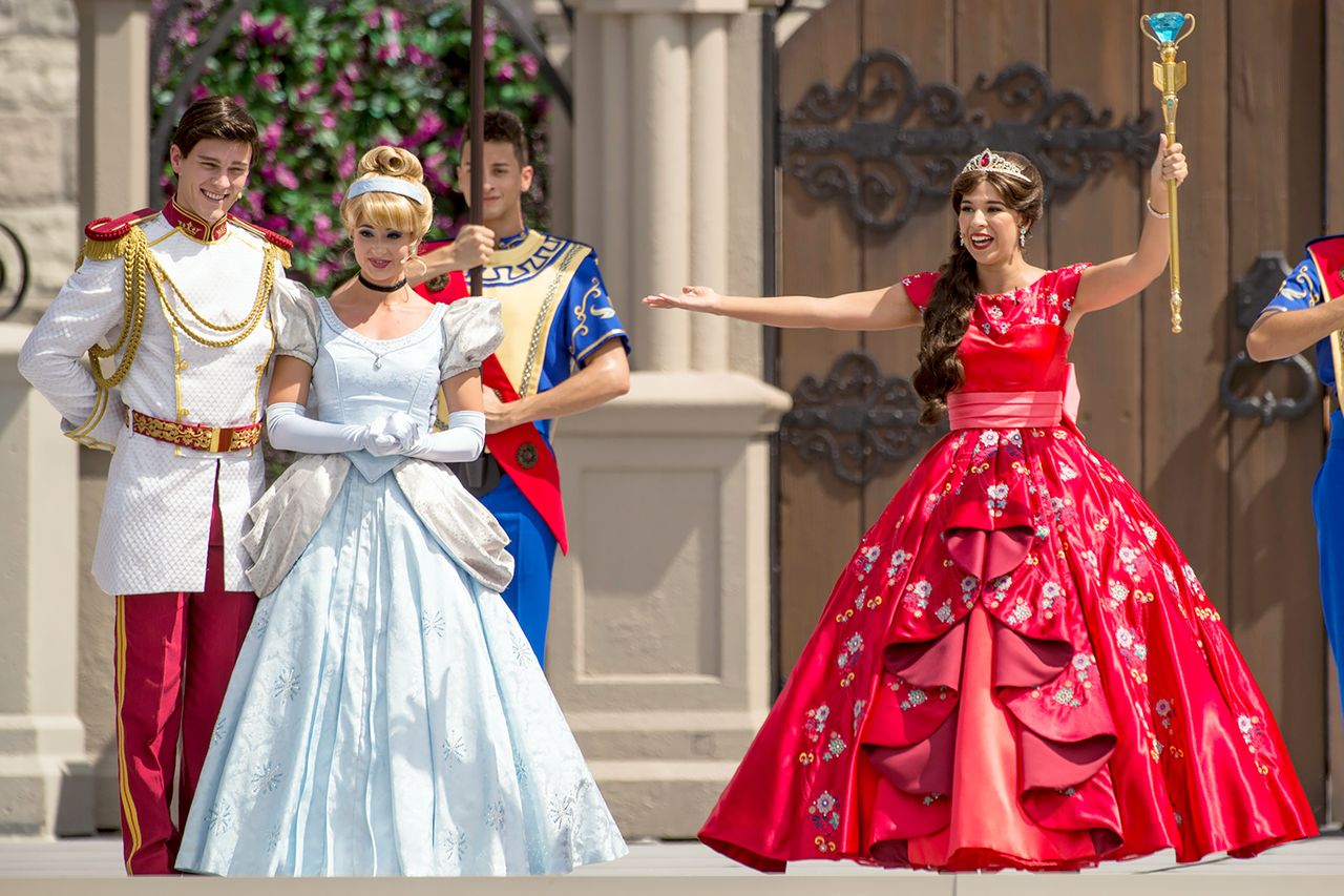 Princess Elena of Avalor performing with Cinderella and Prince Charming in front of a castle setting
