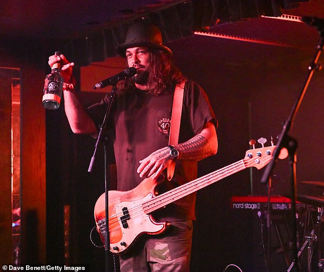 Jason Momoa takes to the stage in London as he plays bass guitar with ...
