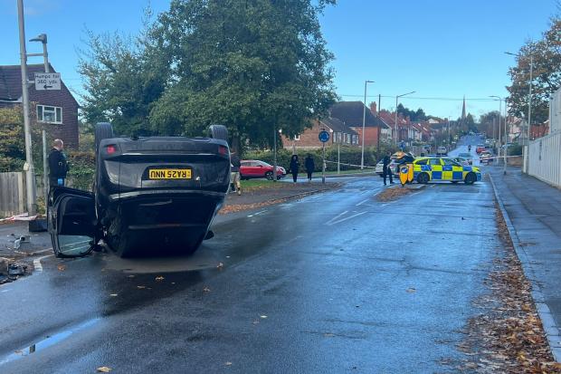 Road closed off after car flips over in crash