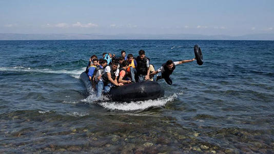 Afghan migrants arrive on the shores of the Greek island of Lesbos after crossing the Aegean sea from Turkey on a inflatable dinghy, 25 September, 2015