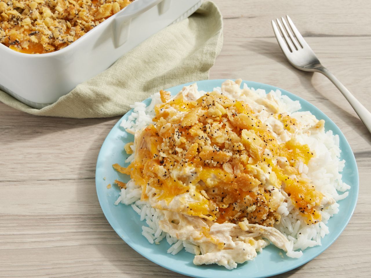 A plate of poppy seed chicken casserole served over white rice