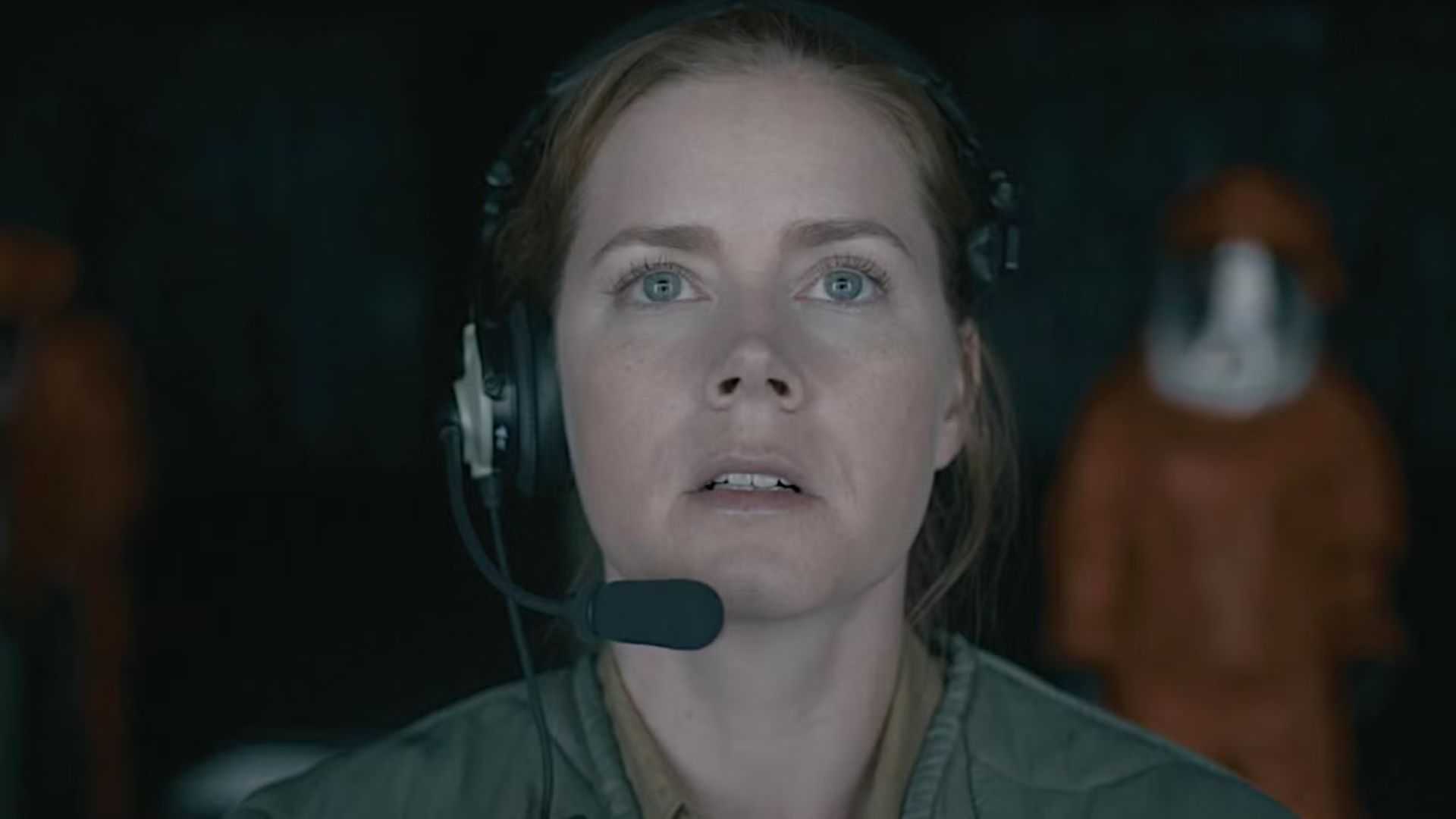 Amy Adams gazes slightly upward with intent focus in a scene from Arrival