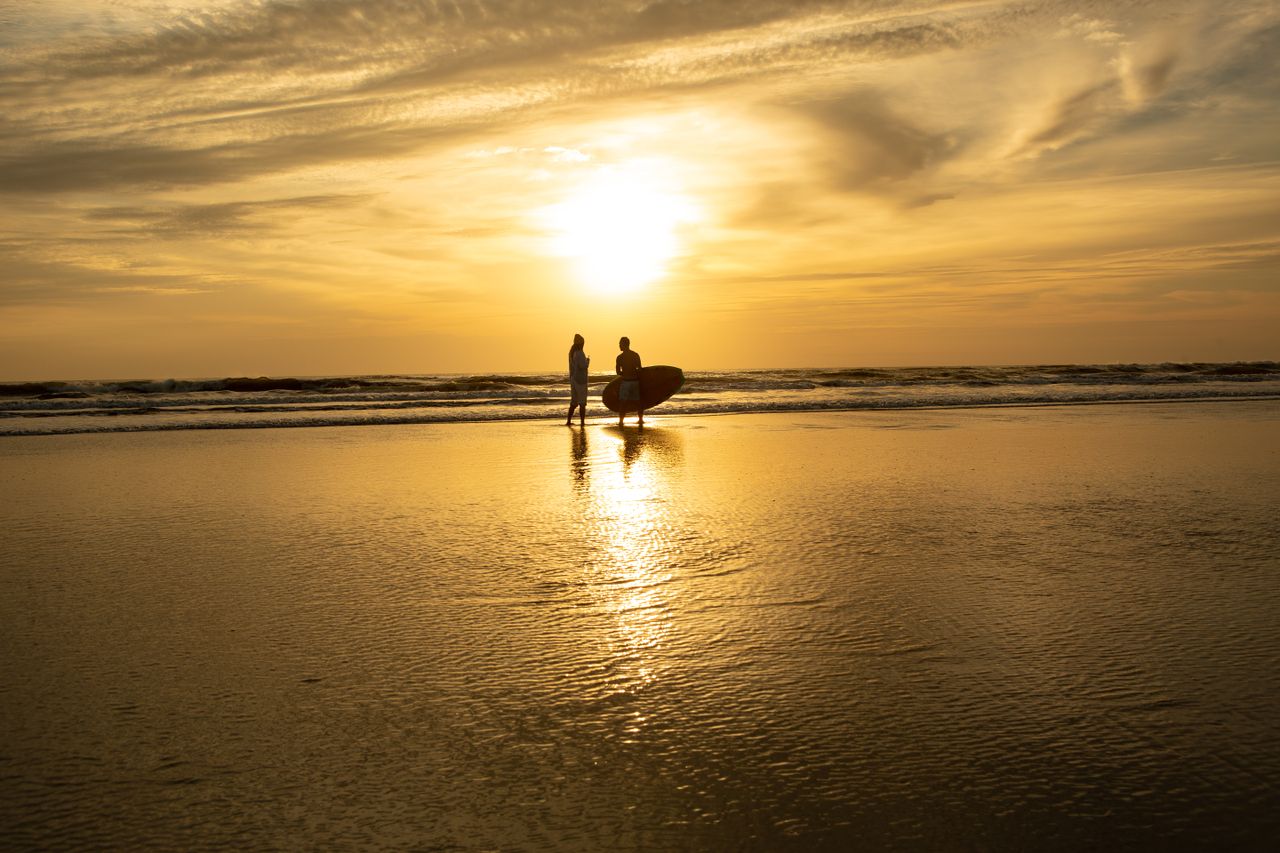 Surfers on New Smyrna Beach