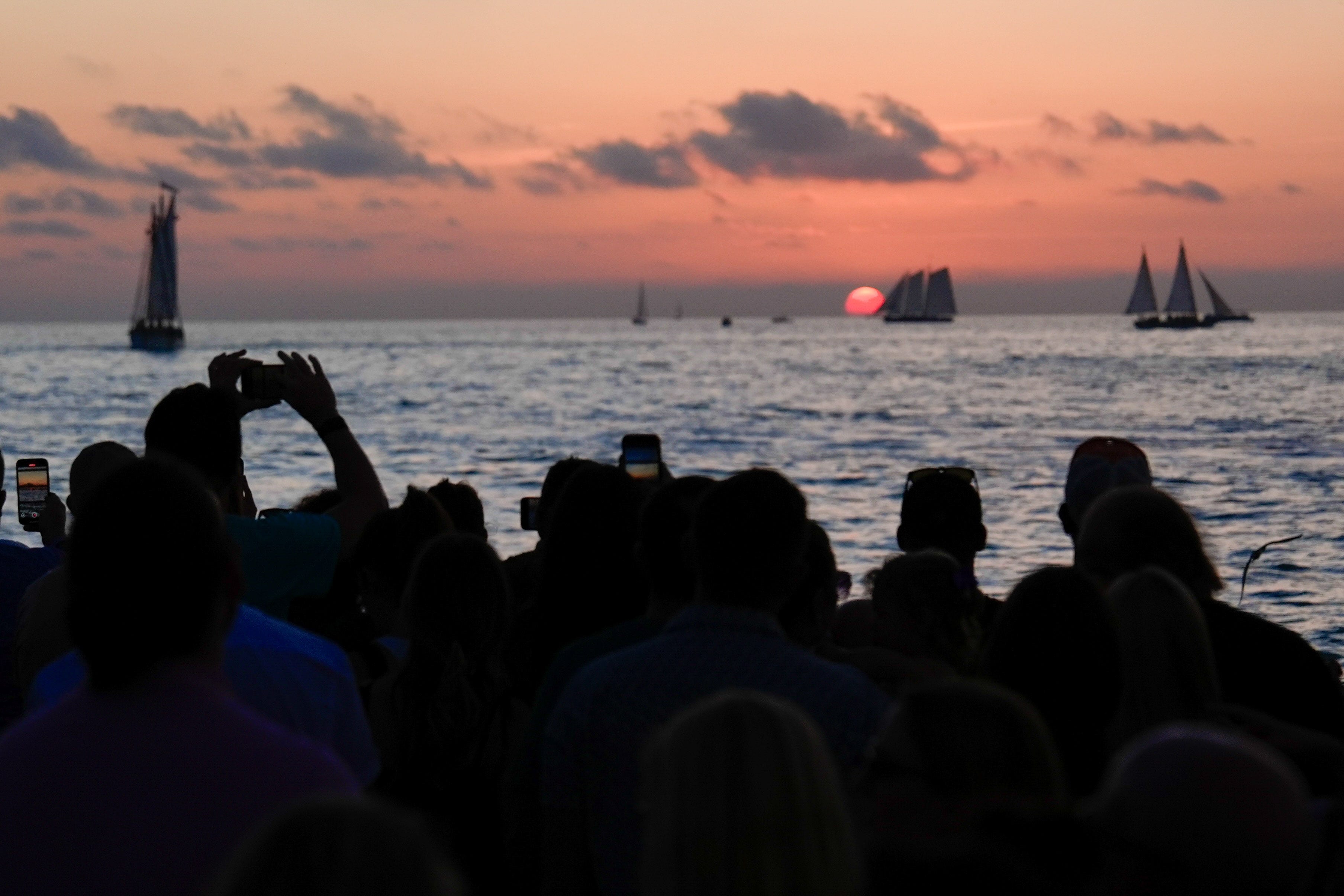 Peopel taking pictures during sunset at Mallory Square