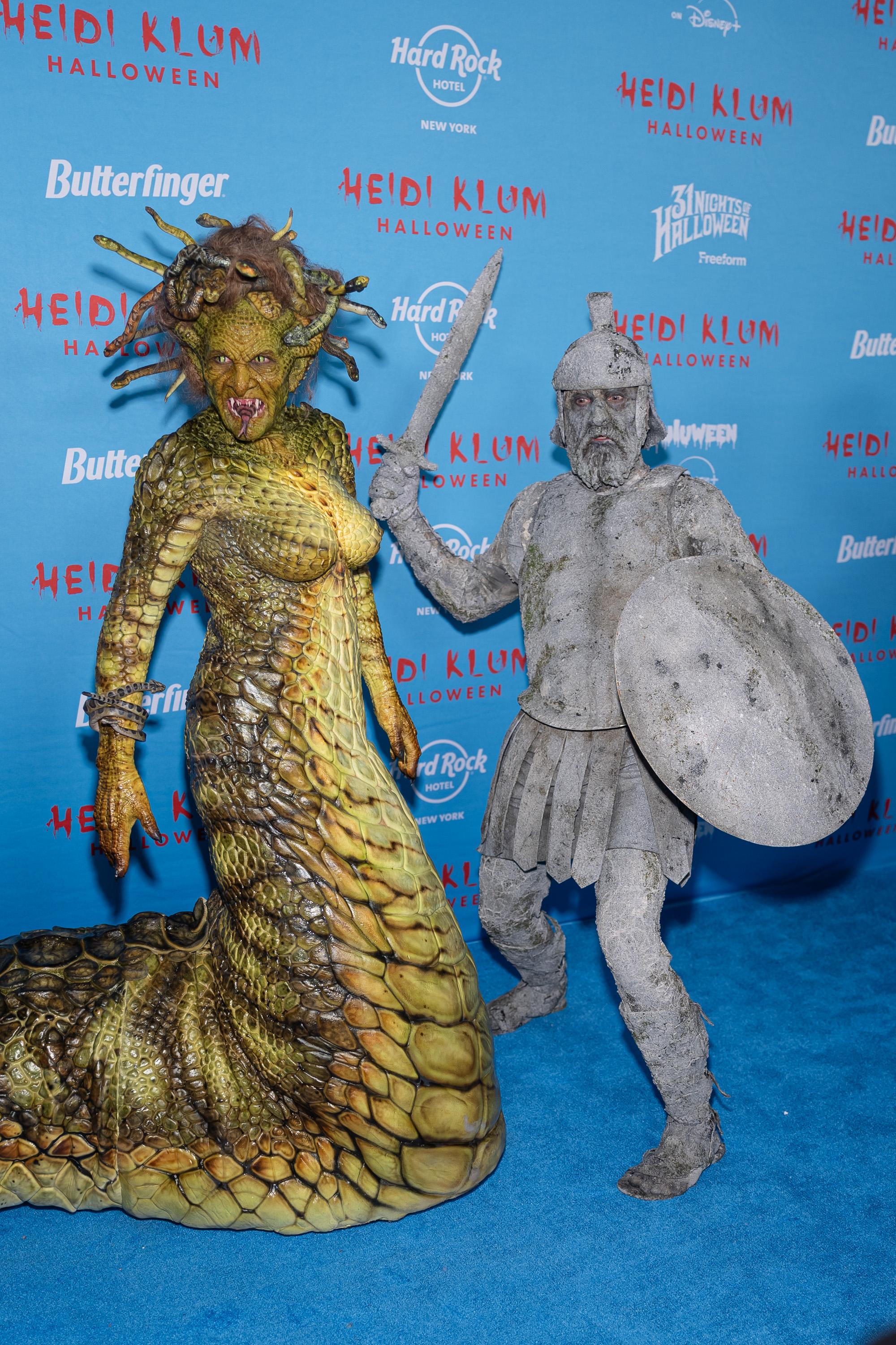 Heidi Klum in a Medusa costume next to Tom Kaulitz in a stone warrior costume.