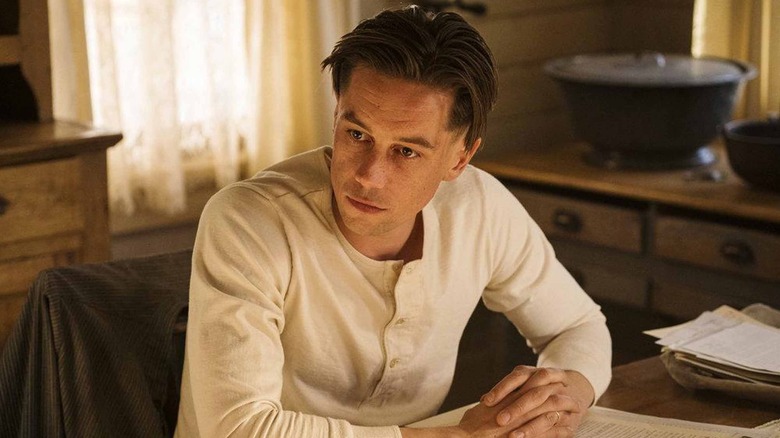 Killian Scott as Seth Davenport sitting at a table in Damnation