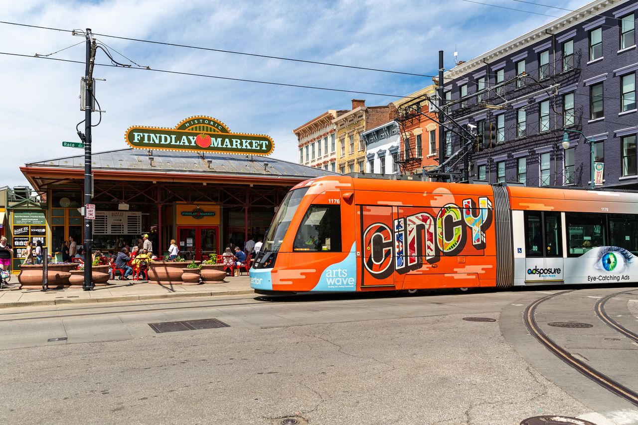 Cincinnati streetcar in front of Findlay Market with people visible around the area