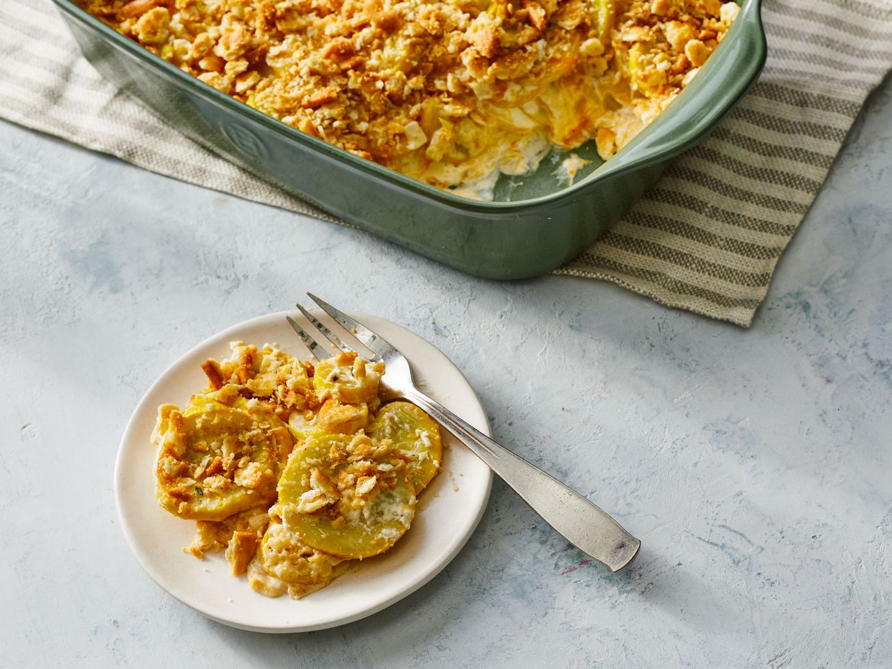 Southern Living Old School Squash Casserole with a serving scooped out onto a plate with a fork