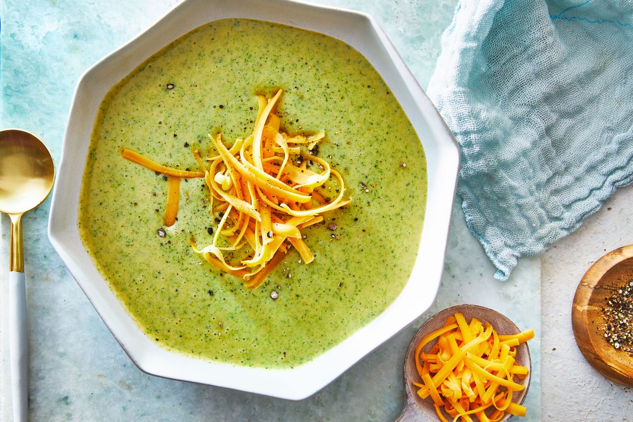Southern Living Broccoli Cheddar Soup in a bowl to serve topped with extra shredded cheddar