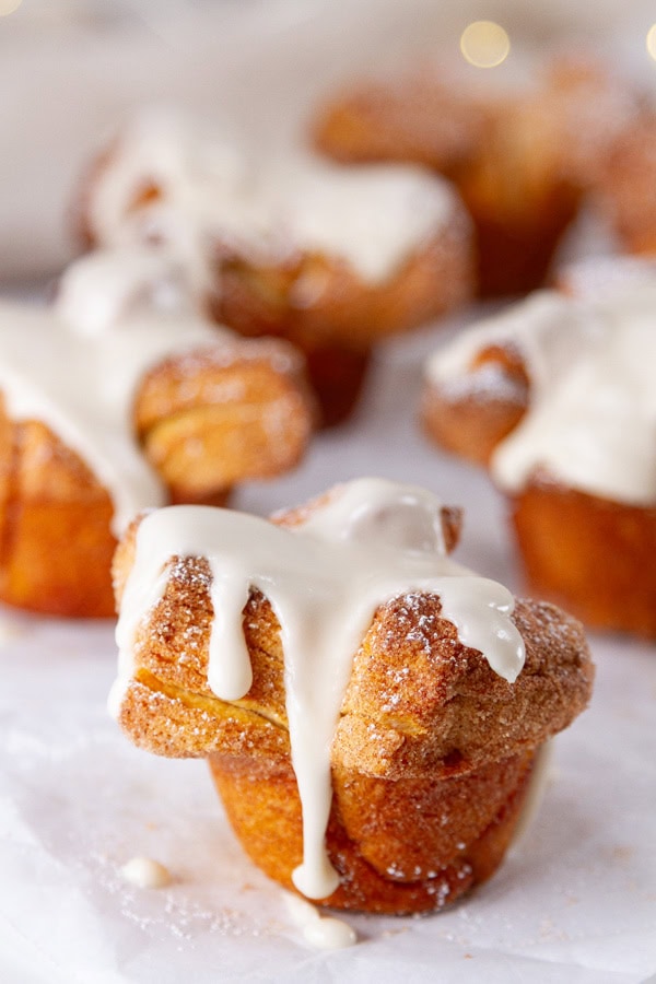cinnamon buns with icing on them.