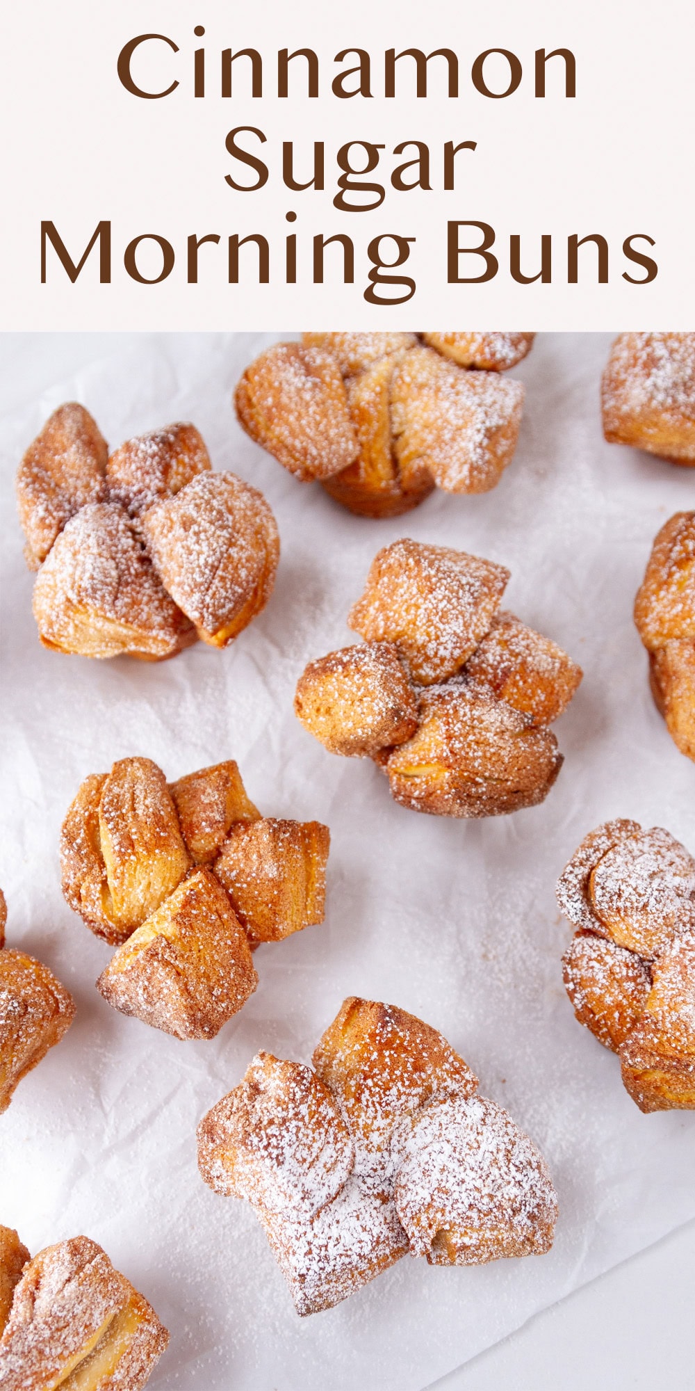 several pull apart Monkey Bread Muffins on a piece of white parchment paper.