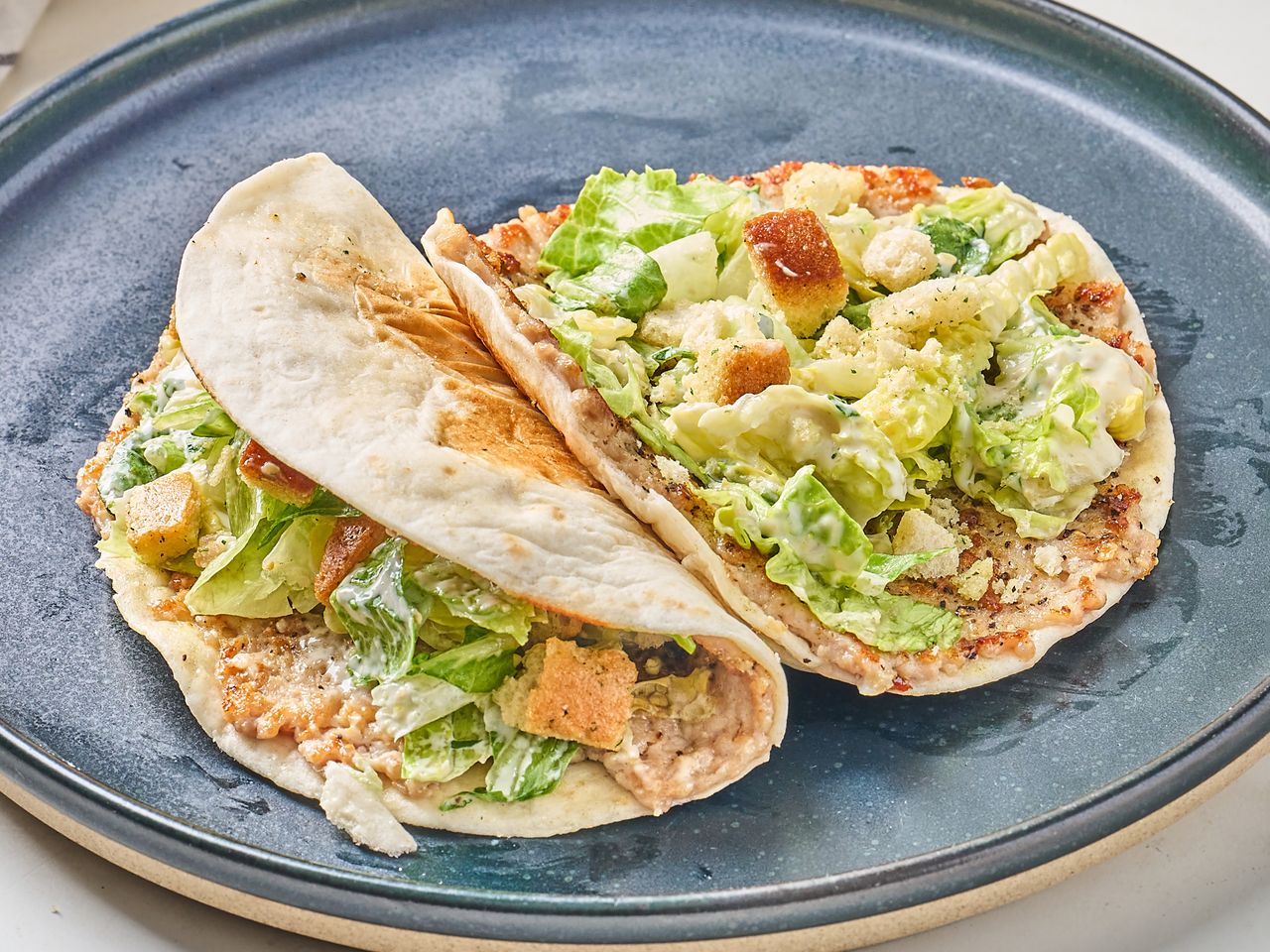 Chicken Caesar salad tacos served on a plate