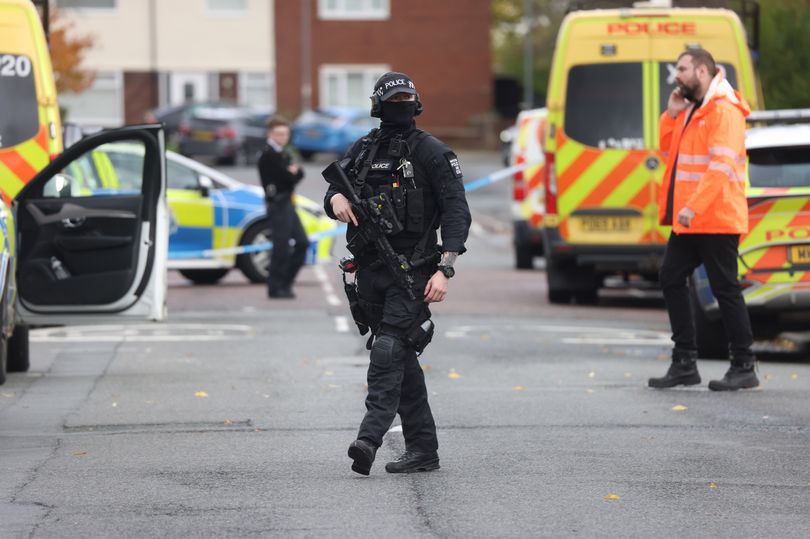 Armed police descend on street and evacuate flats as man arrested