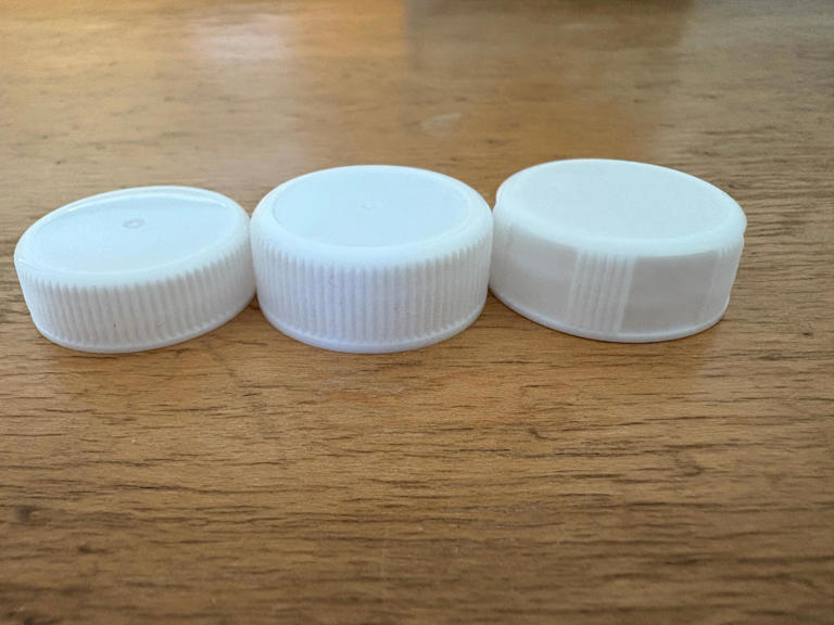 Get a grip. New, taller milk carton caps are easier to grasp, twist