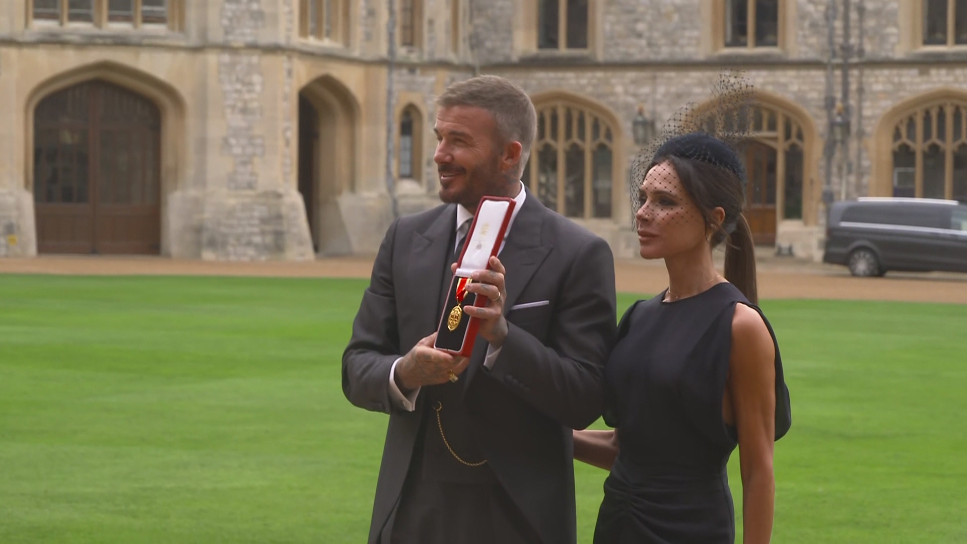 Beckham poses with wife Victoria after receiving knighthood