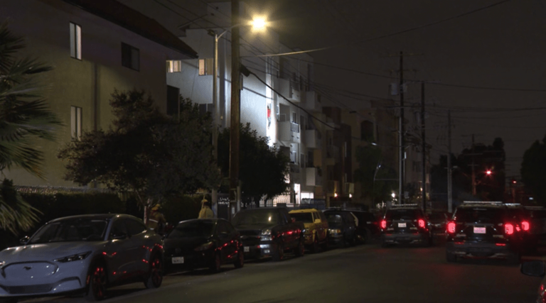 Man throwing items in L.A. apartment building hangs out of window