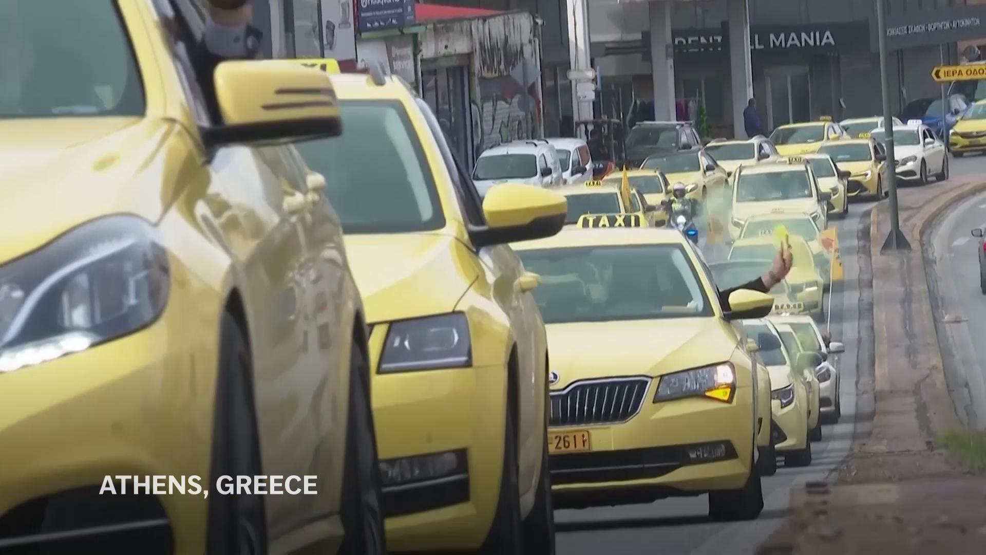 Parade of yellow taxis through Athens as drivers begin 48-hour strike