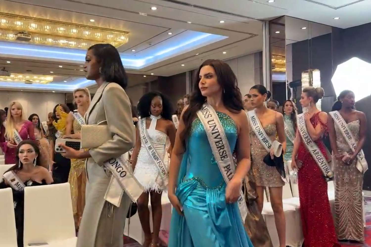 Miss Universe Thailand/Facebook Miss Universe contestants get up to walk out of event on Nov. 4, 2025.