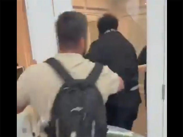  This screenshot from an unverified video is said to be from the Students Supporting Israel event shows a man pushing back an anti-Israel protester who broke through a glass door.