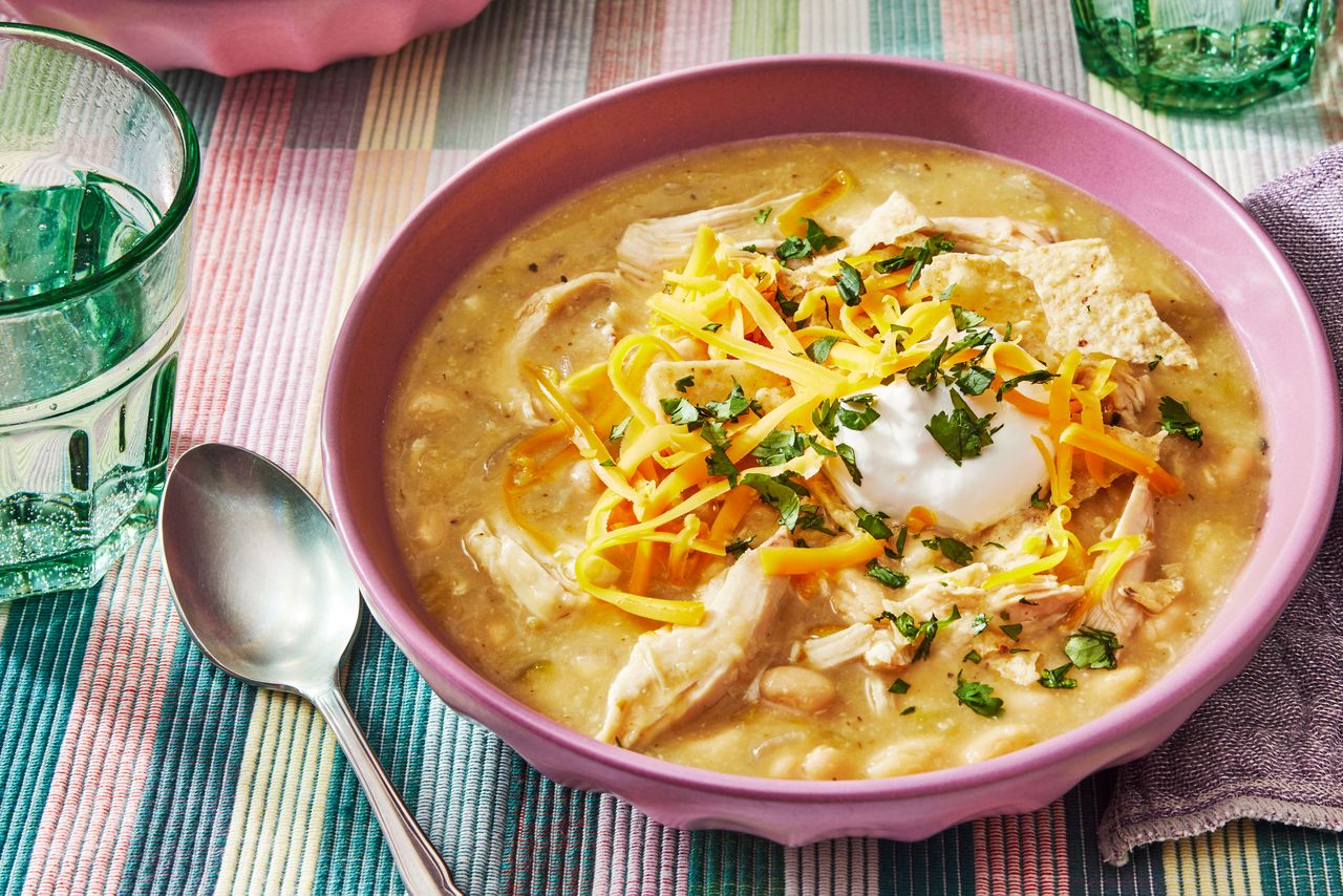 Southern Living White Bean Chicken Chili in a bowl to serve topped with sour cream and cheese