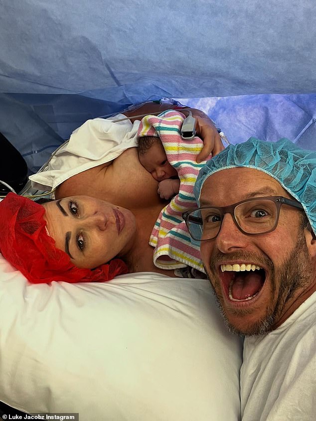 Luke was very much in doting dad mode, proudly beaming as he cradled his son